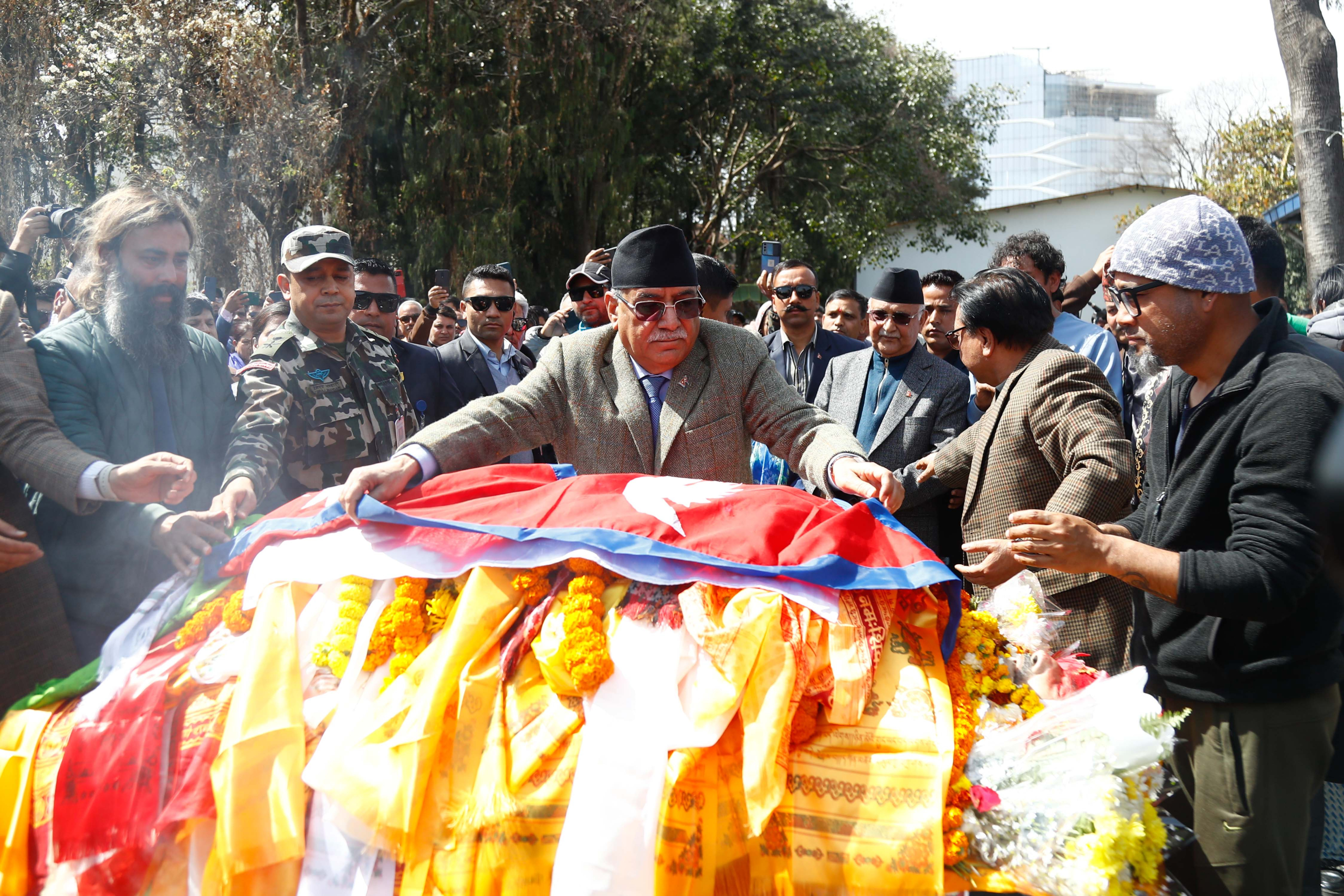 प्रधानमन्त्रीद्वारा स्व. भक्तराज आचार्यको पार्थिव शरीरमा राष्ट्रिय झण्डा ओडाउँदै (तस्बिरहरु)